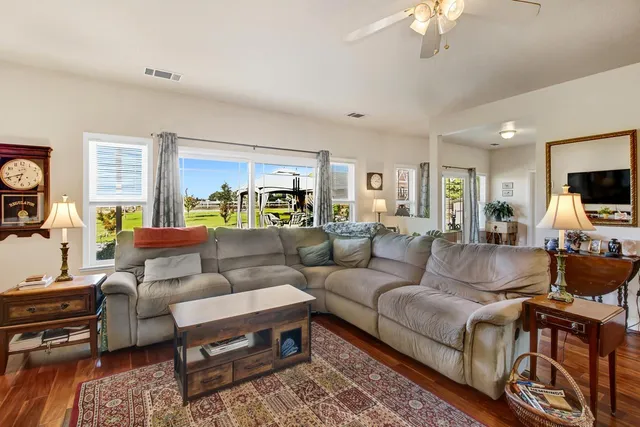 a kitchen that has a lot of cabinets in it and wooden floors