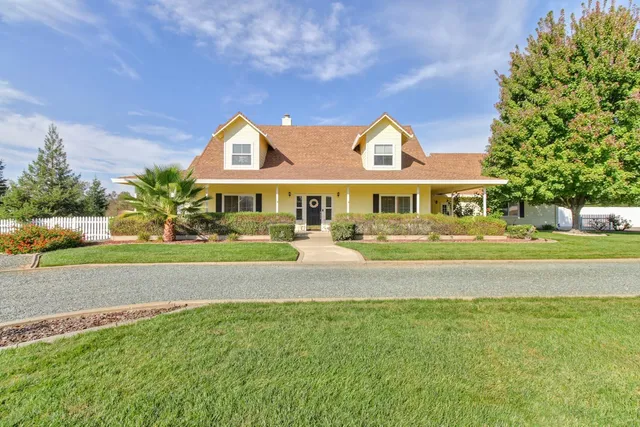 a view of a brick house with large windows