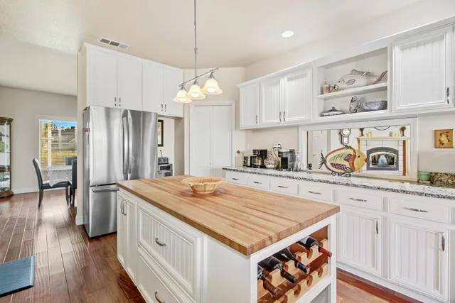 a living room with furniture a flat screen tv and a large window