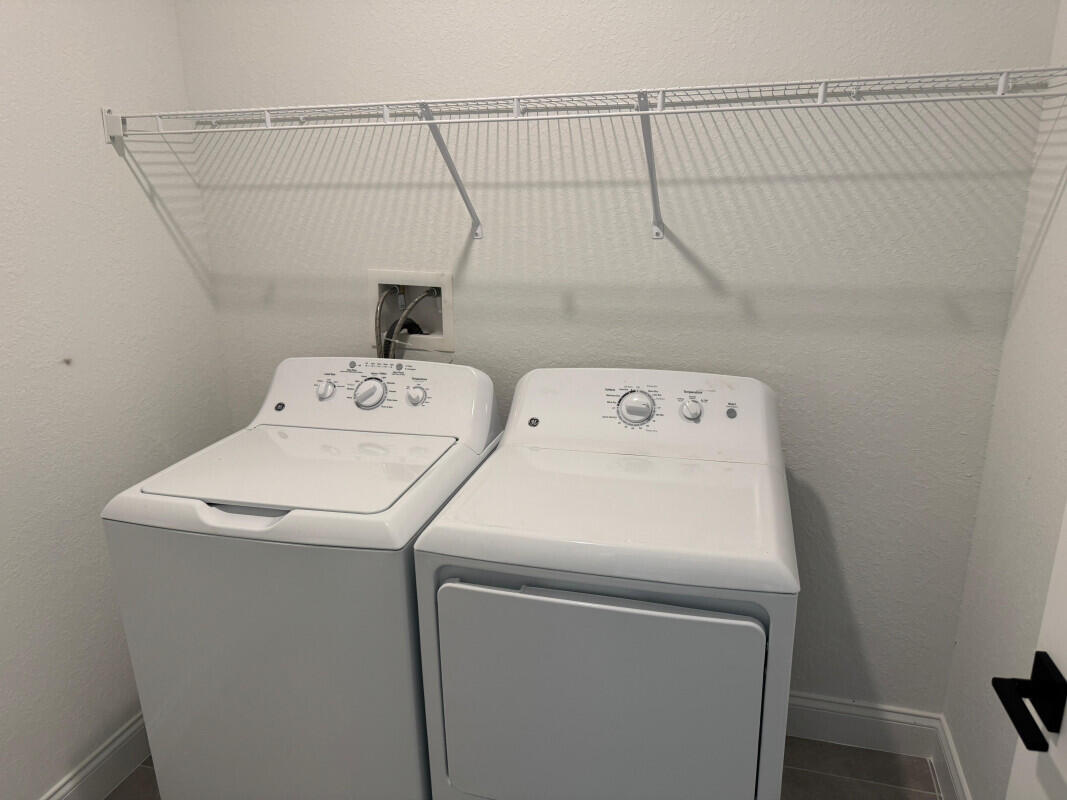 1073 Southwest Benchor Avenue Port St. Lucie, FL 34953 - Photo 12 of 23 a utility room with dryer and washer