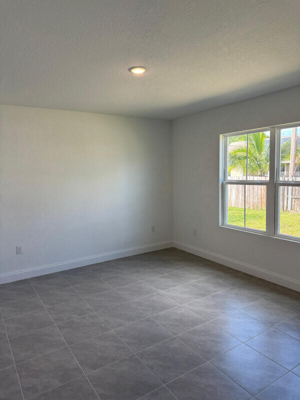 1073 Southwest Benchor Avenue Port St. Lucie, FL 34953 - Photo 14 of 23 an empty room with a window