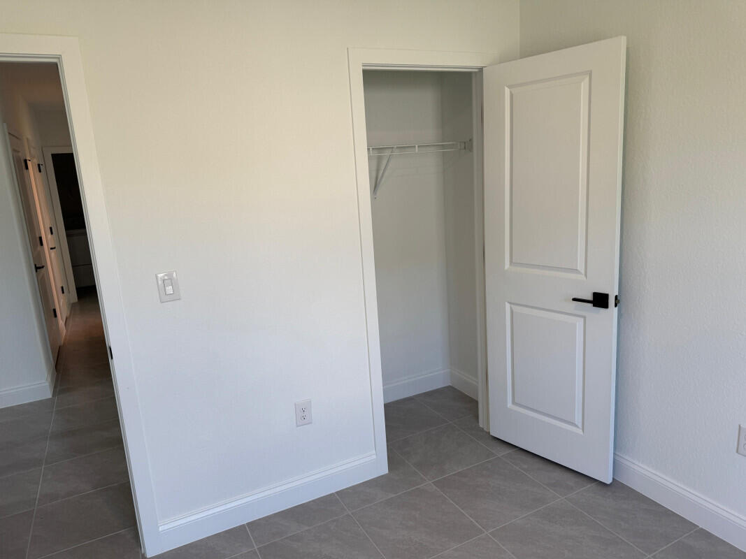 1073 Southwest Benchor Avenue Port St. Lucie, FL 34953 - Photo 16 of 23 an empty room with windows