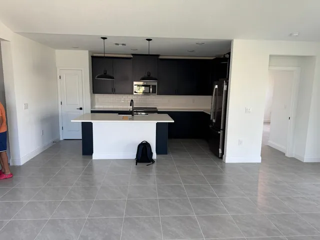 a kitchen with stainless steel appliances a sink and cabinets