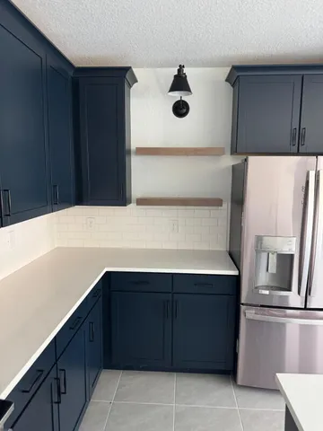 a kitchen with a cabinets and refrigerator