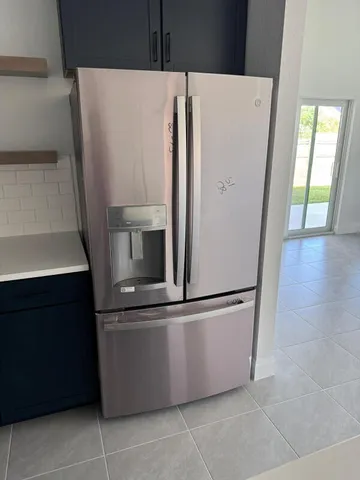a view of kitchen with stainless steel appliances wooden floor