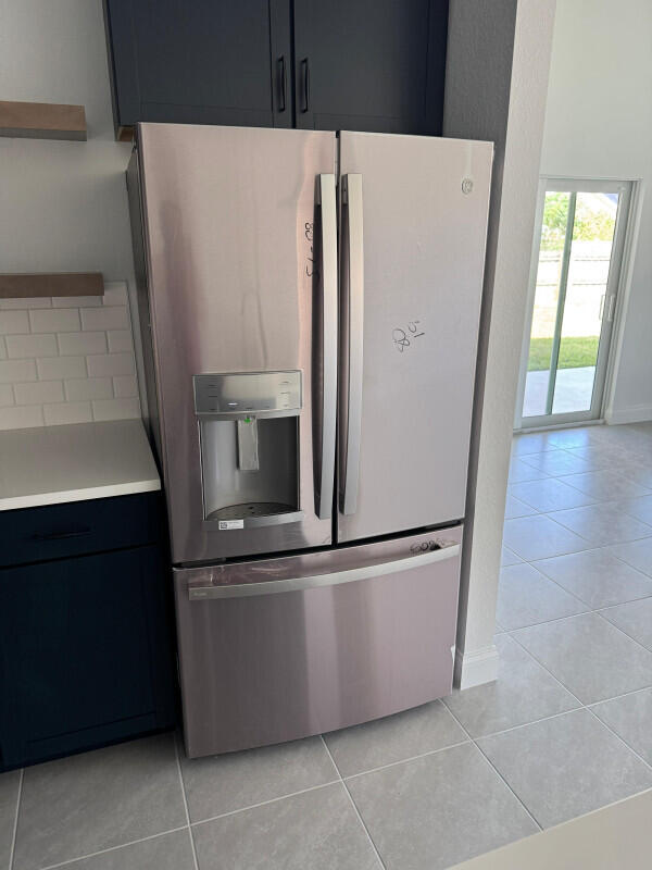 1073 Southwest Benchor Avenue Port St. Lucie, FL 34953 - Photo 5 of 23 a view of kitchen with stainless steel appliances wooden floor