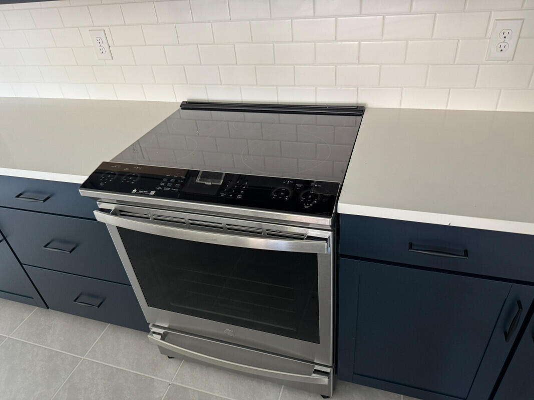 1073 Southwest Benchor Avenue Port St. Lucie, FL 34953 - Photo 6 of 23 a stove top oven sitting inside of a kitchen