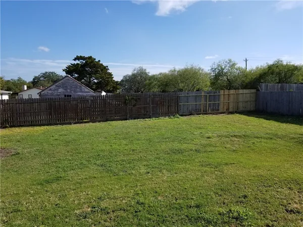 a swimming pool that is in front of a house