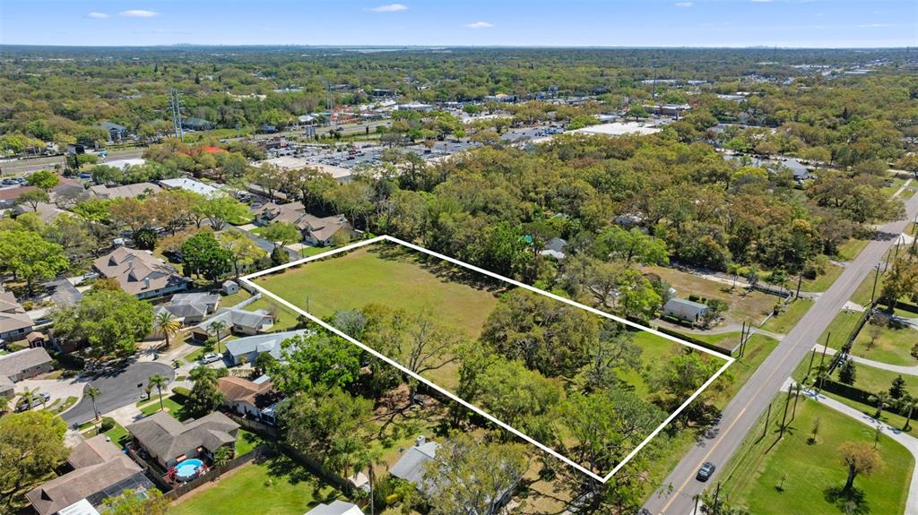 854 Riviere Road Palm Harbor, FL 34683 - Photo 2 of 5 an aerial view of residential houses with outdoor space and mountain view