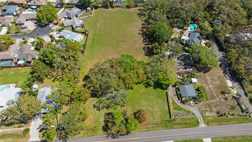 854 Riviere Road Palm Harbor, FL 34683 - Photo 5 of 5 an aerial view of residential houses with outdoor space and trees all around