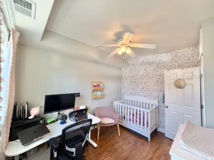 a bedroom with a bed and a chandelier