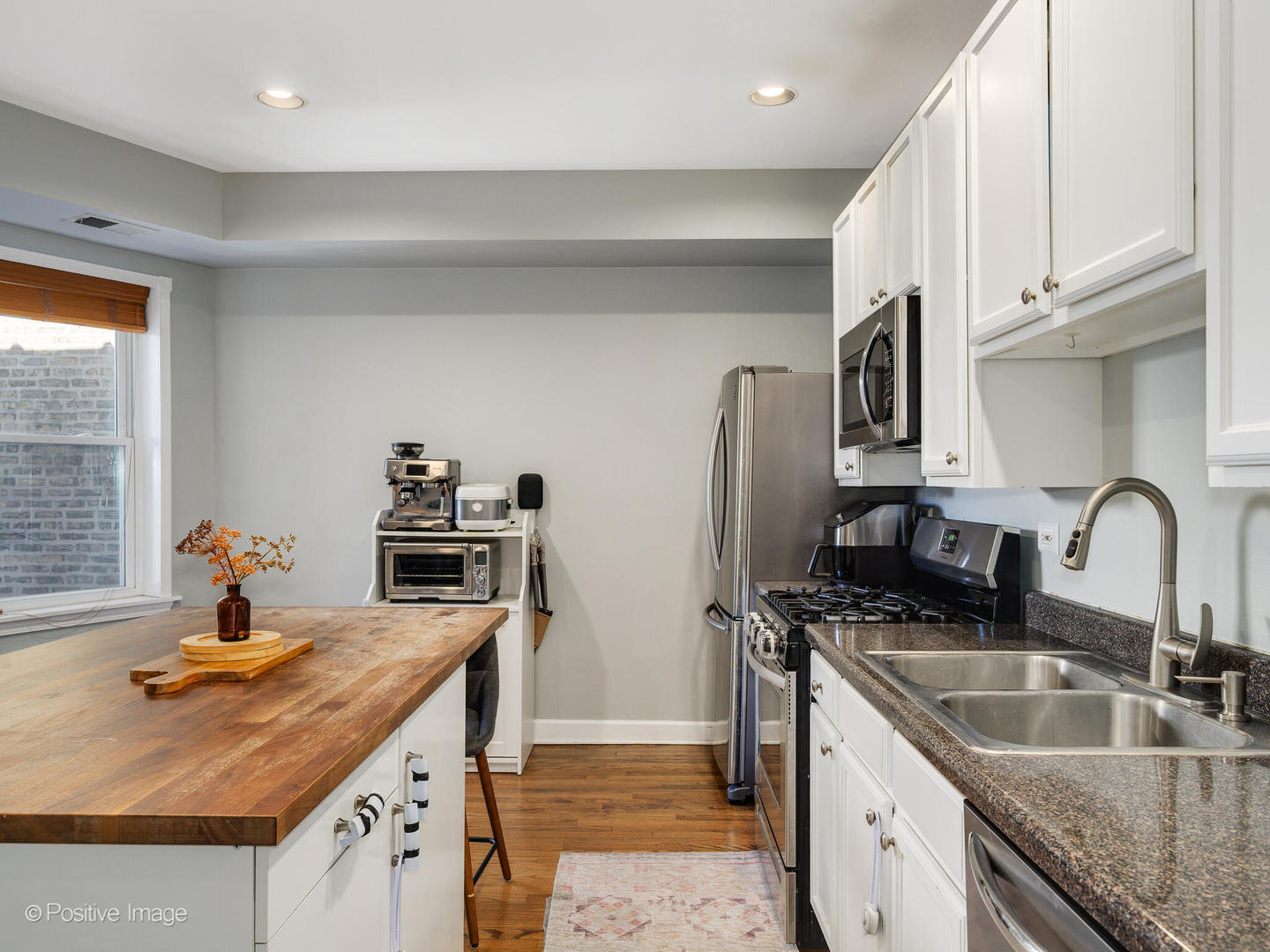 4022 North Monticello Avenue, Unit 3N Chicago, IL 60618 - Photo 8 of 21 a kitchen with stainless steel appliances granite countertop a sink a stove and a refrigerator