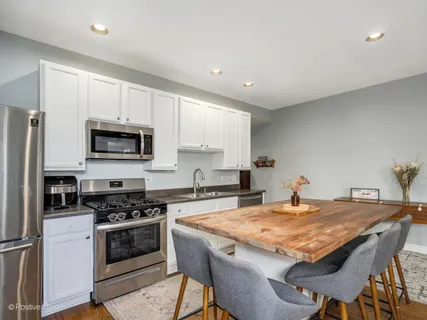 a kitchen with a stove a sink and a refrigerator