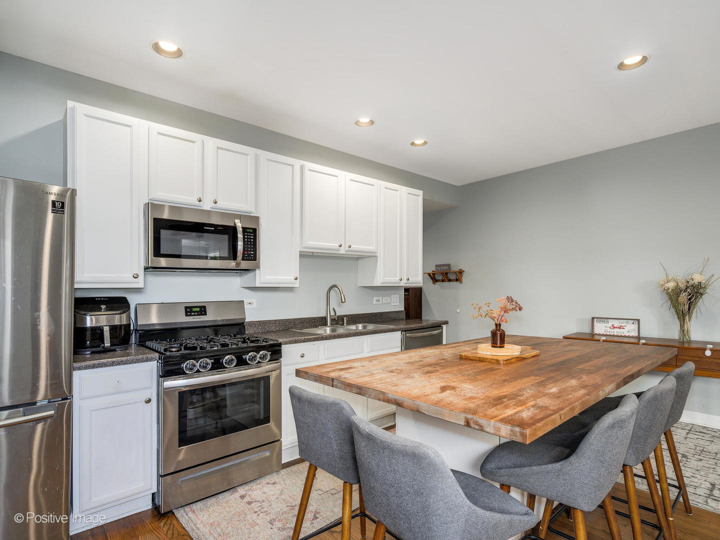 4022 North Monticello Avenue, Unit 3N Chicago, IL 60618 - Photo 9 of 21 a kitchen with a stove a sink and a refrigerator