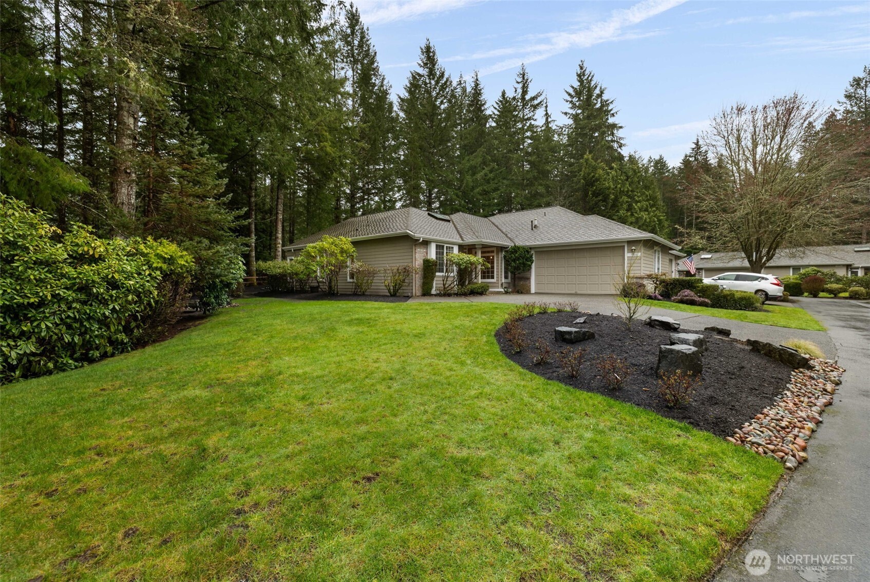 7033 Prestwick Lane Southwest Port Orchard, WA 98367 - Photo 1 of 39 a view of a house with a yard and sitting area