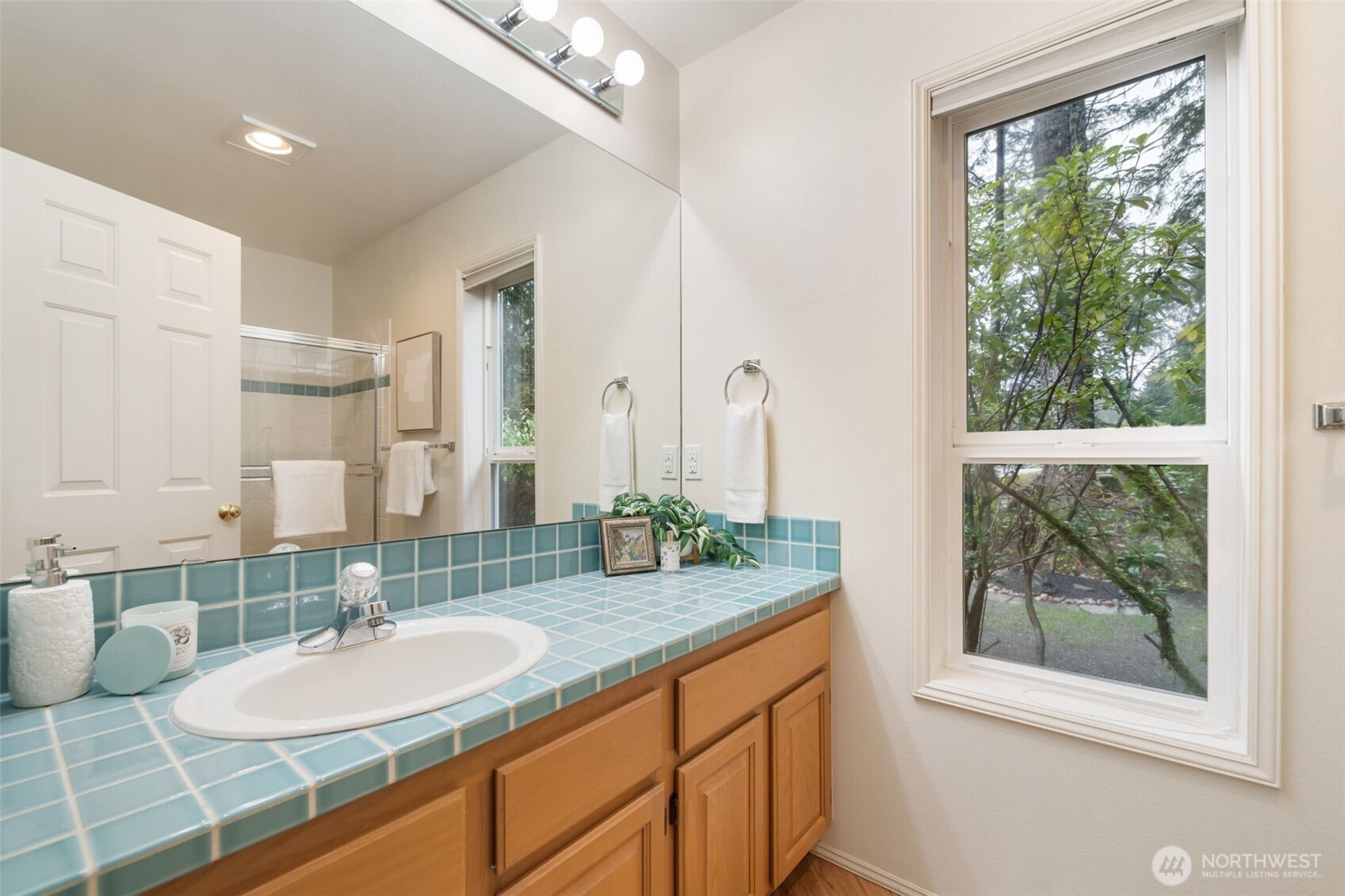7033 Prestwick Lane Southwest Port Orchard, WA 98367 - Photo 17 of 39 a bathroom with a granite countertop sink and a mirror
