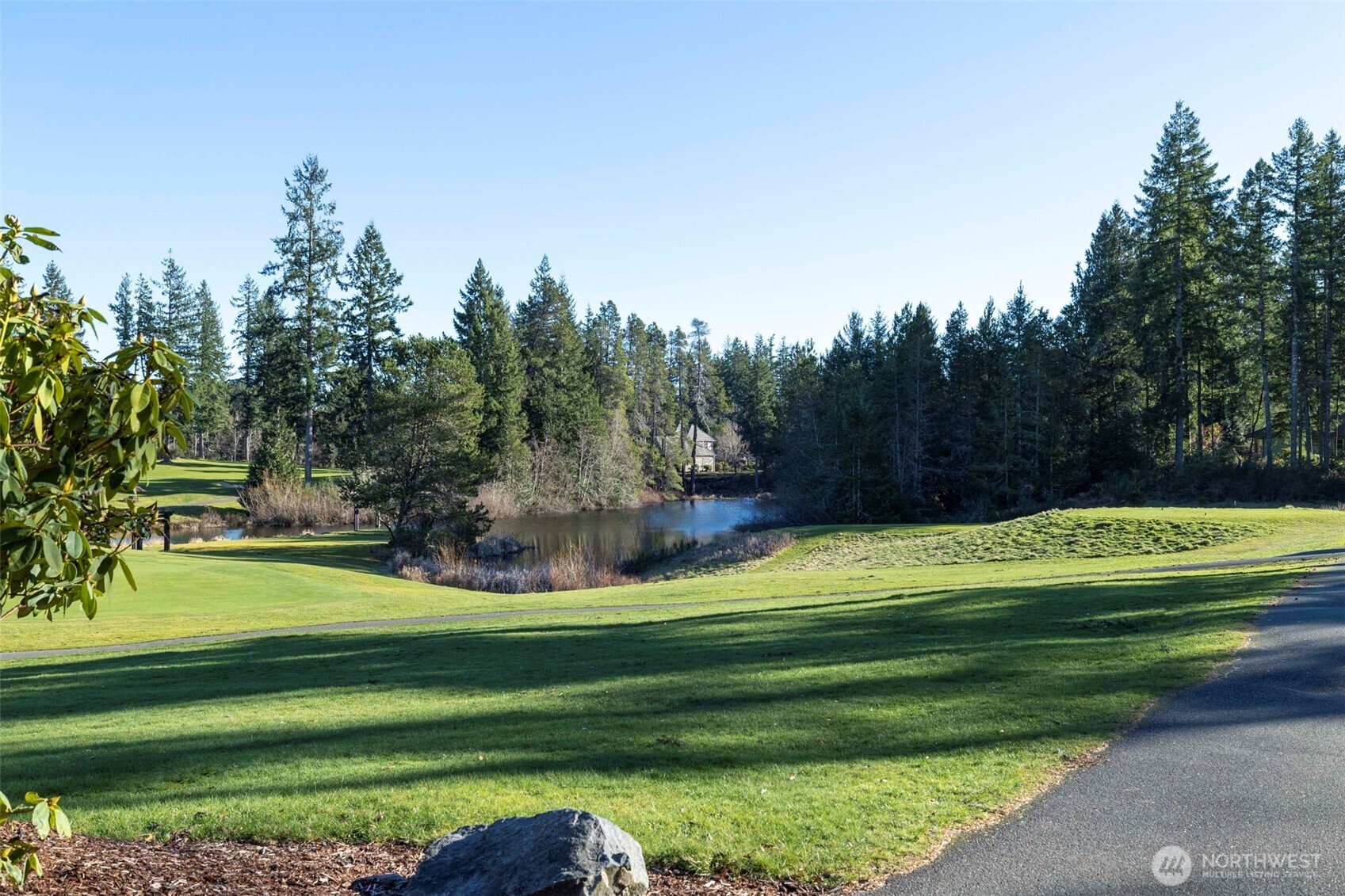 7033 Prestwick Lane Southwest Port Orchard, WA 98367 - Photo 36 of 39 a green field with trees in the background