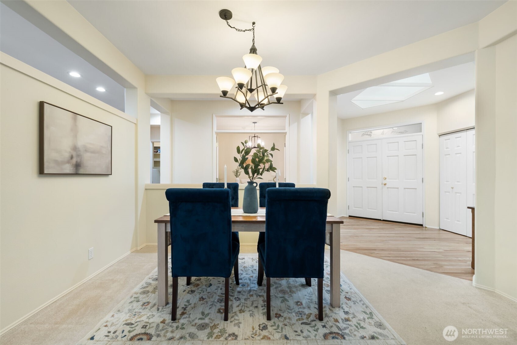 7033 Prestwick Lane Southwest Port Orchard, WA 98367 - Photo 6 of 39 a view of a dining room with furniture a chandelier and wooden floor