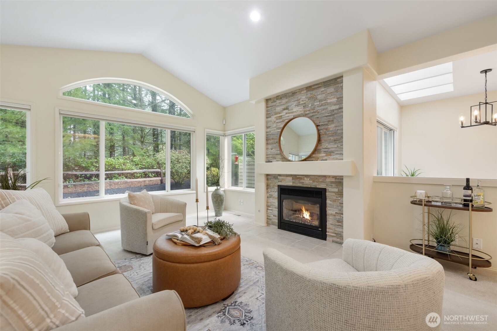 7033 Prestwick Lane Southwest Port Orchard, WA 98367 - Photo 7 of 39 a living room with furniture a fireplace and a floor to ceiling window