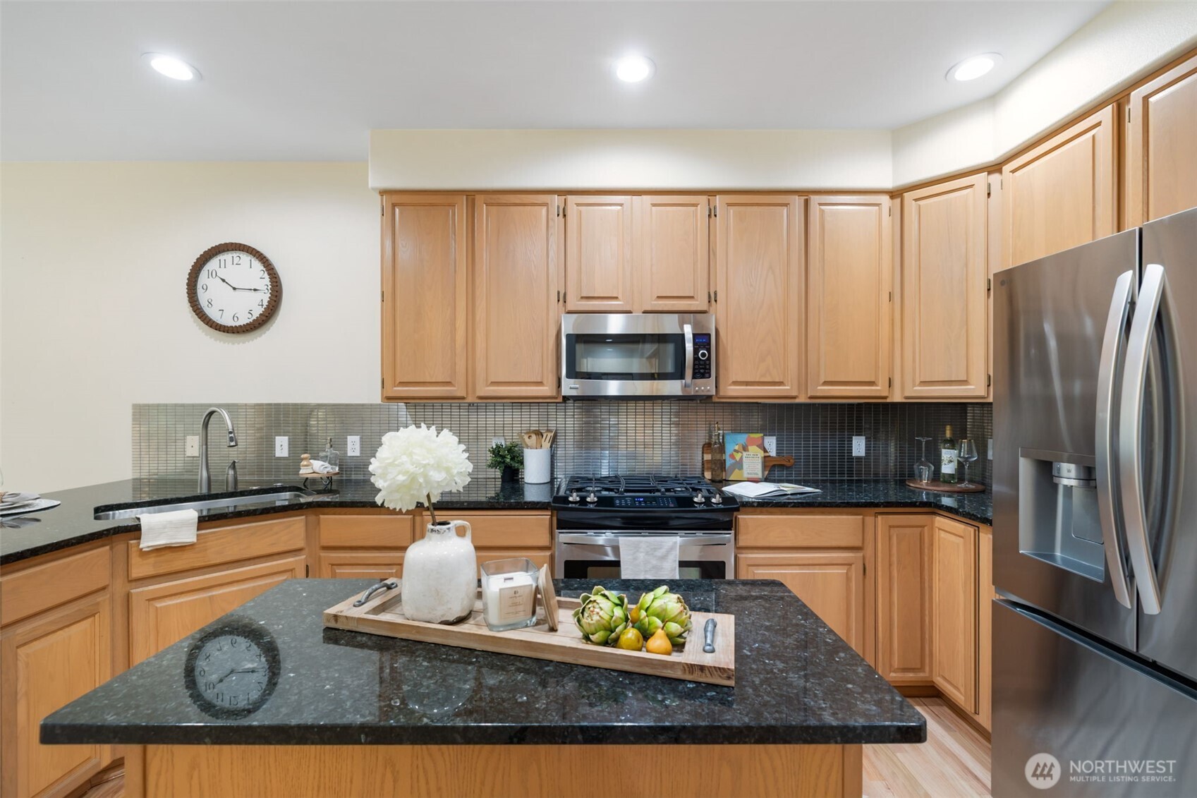 7033 Prestwick Lane Southwest Port Orchard, WA 98367 - Photo 10 of 39 a kitchen with stainless steel appliances granite countertop a refrigerator a stove top oven a sink and dishwasher