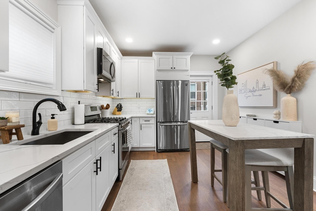 43 Alfred Street, Unit A Everett, MA 02149 - Photo 13 of 29 a kitchen with white cabinets appliances and sink