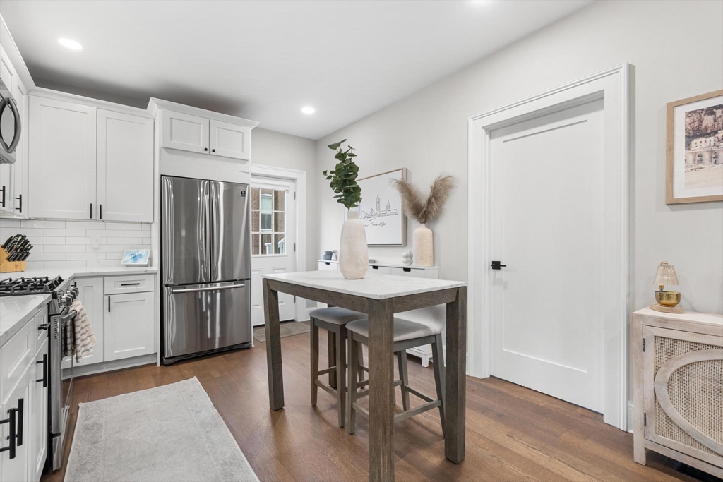 43 Alfred Street, Unit A Everett, MA 02149 - Photo 14 of 29 a kitchen with a refrigerator a stove a sink dishwasher with a dining table and chairs