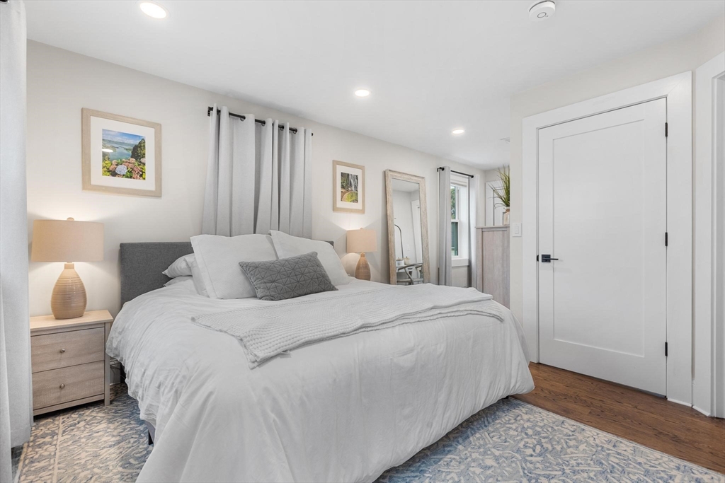 43 Alfred Street, Unit A Everett, MA 02149 - Photo 21 of 29 a large bed sitting in a bedroom and a table