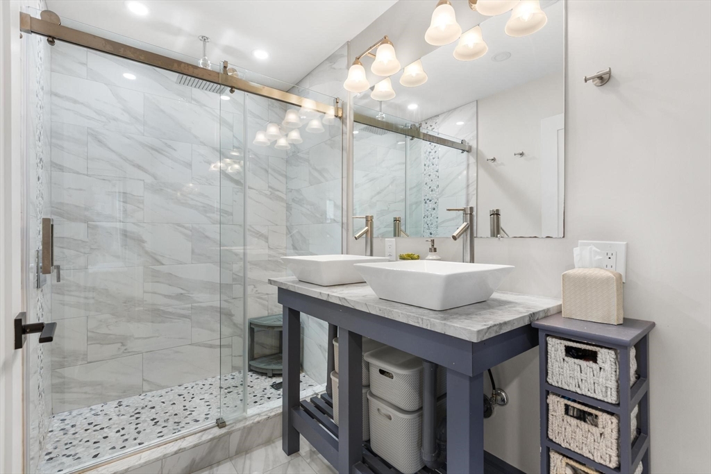 43 Alfred Street, Unit A Everett, MA 02149 - Photo 24 of 29 a bathroom with a granite countertop sink a mirror and a shower