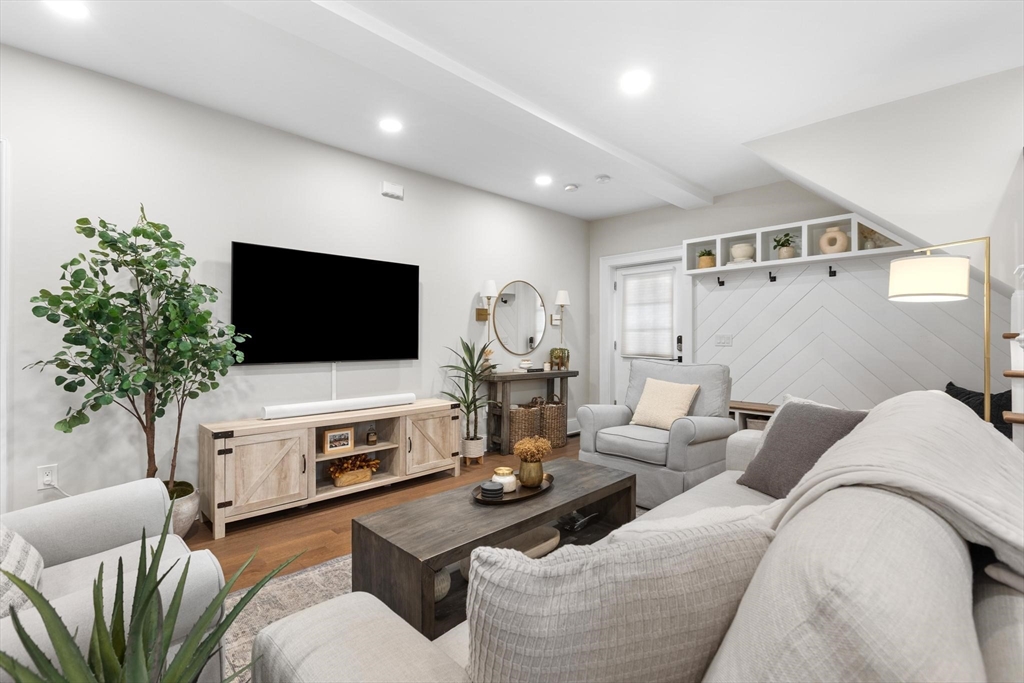 43 Alfred Street, Unit A Everett, MA 02149 - Photo 6 of 29 a living room with furniture a flat screen tv and a fireplace