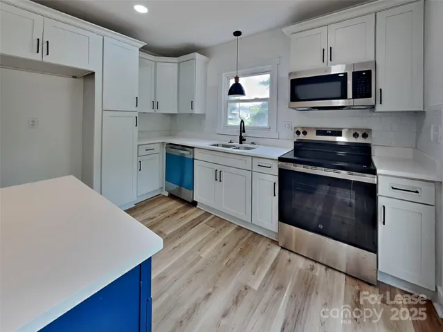 a spacious bedroom with a bed and a window