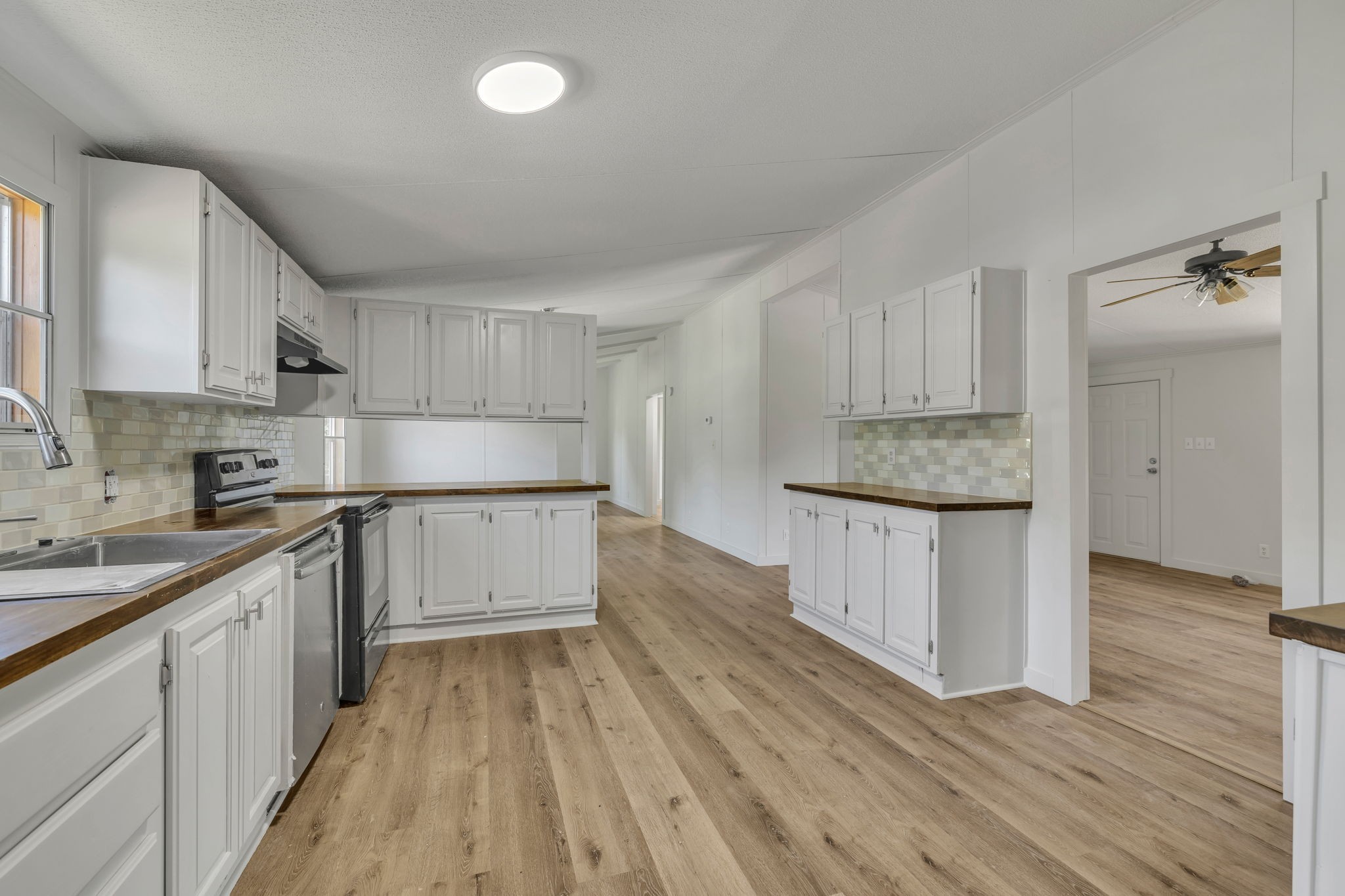 1894 Parker Road Manchester, TN 37355 - Photo 3 of 39 a kitchen with granite countertop white cabinets and white appliances
