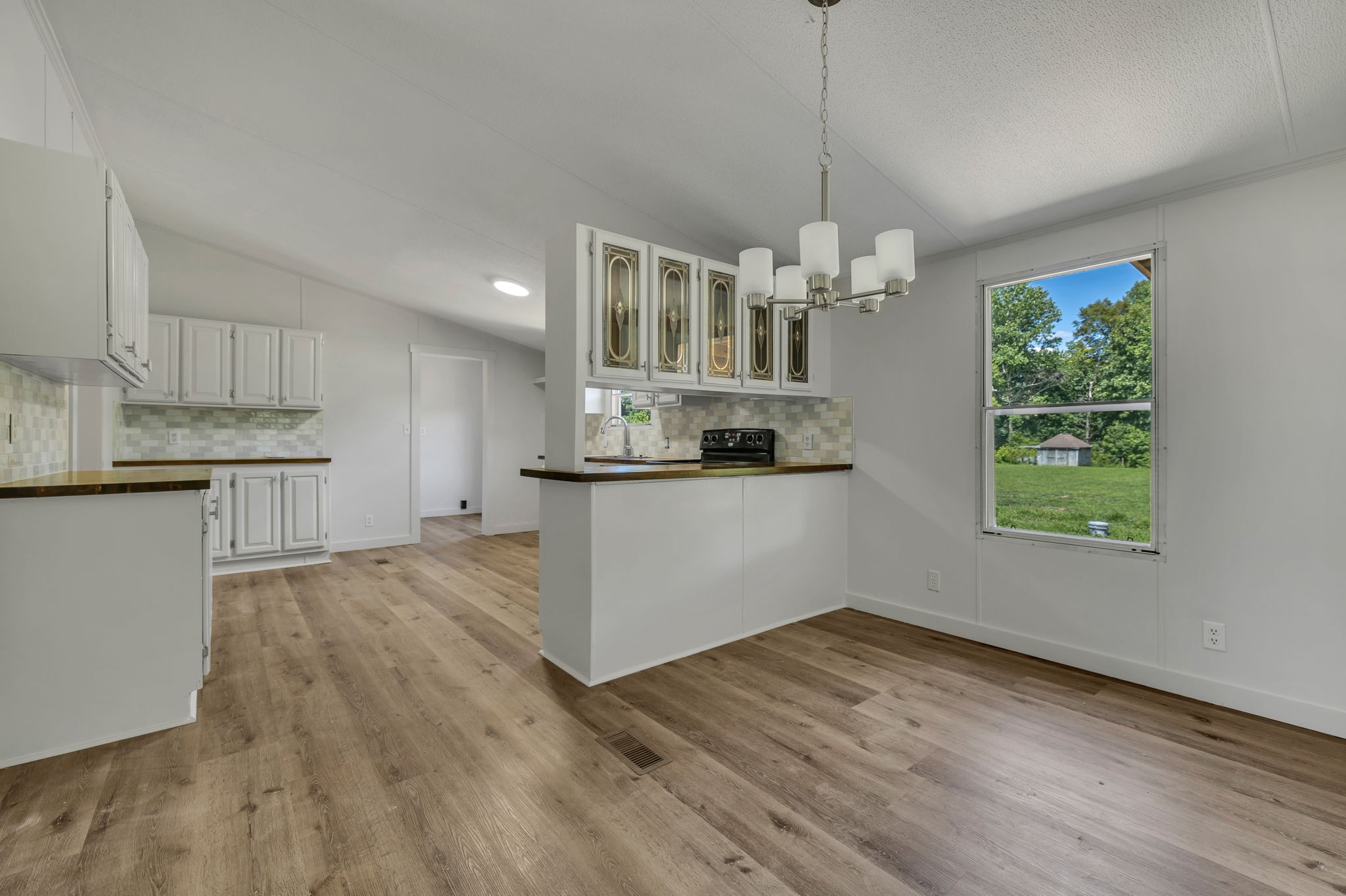 1894 Parker Road Manchester, TN 37355 - Photo 4 of 39 a view of a kitchen with microwave and floor to ceiling window
