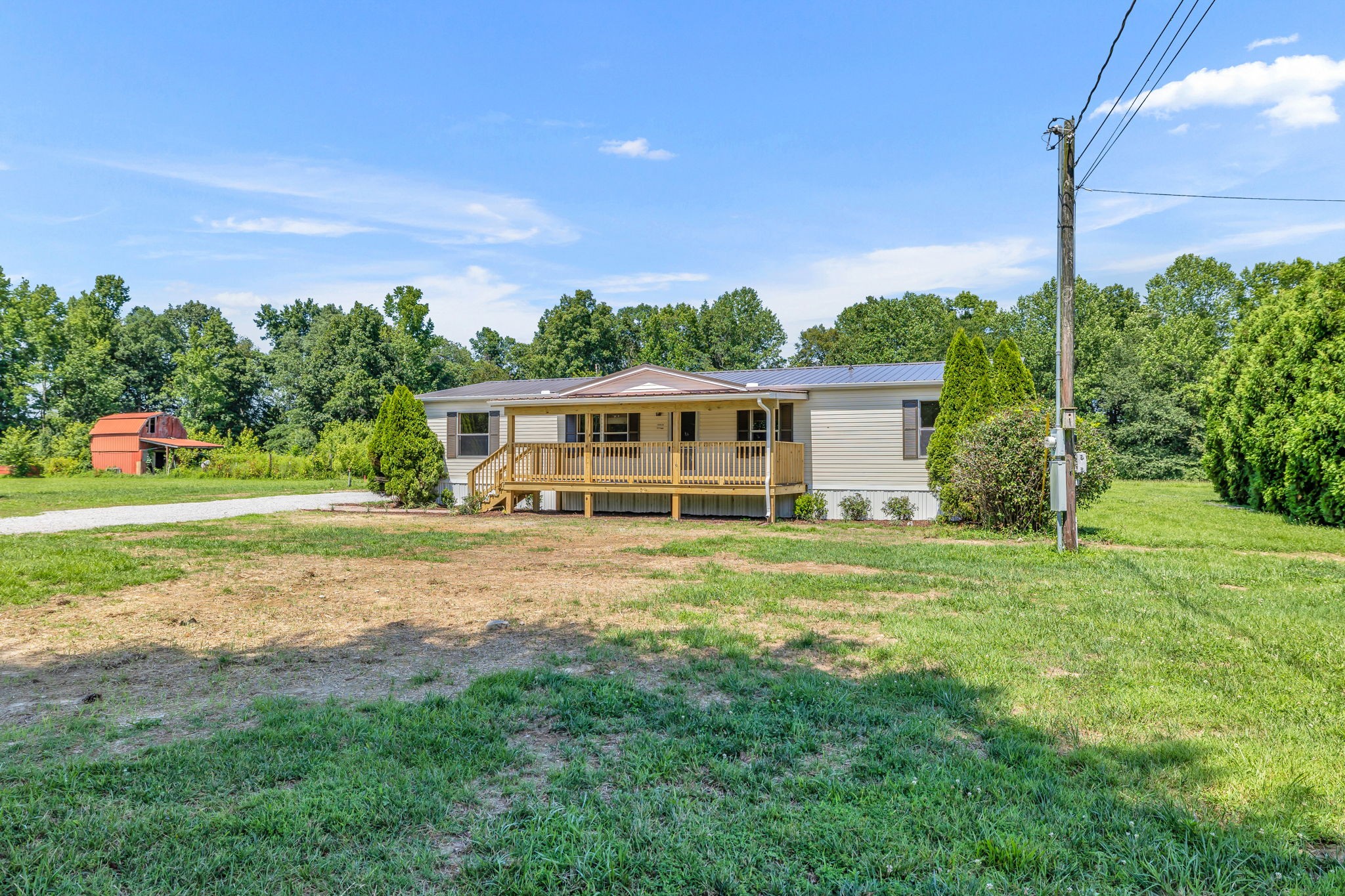 1894 Parker Road Manchester, TN 37355 - Photo 8 of 39 a backyard of a house with plants and wooden fence