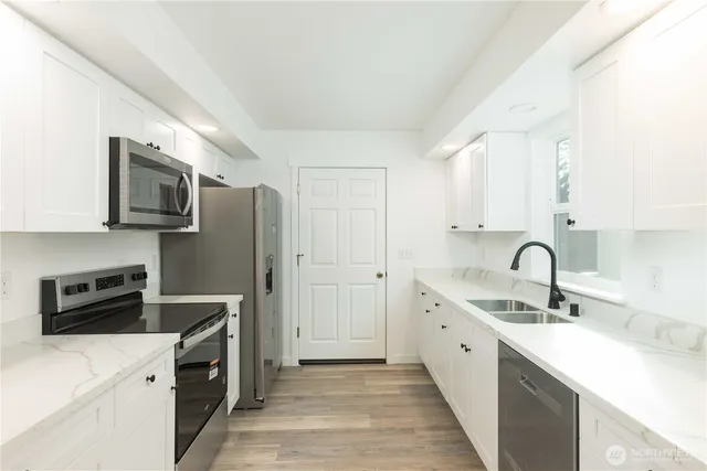 a kitchen with a sink a stove and refrigerator