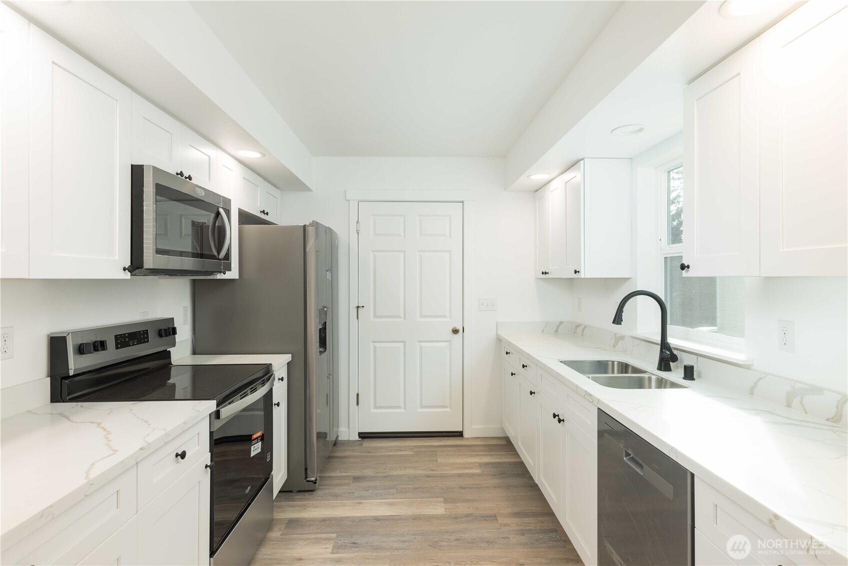 371 East Sullivan Street Allyn, WA 98524 - Photo 5 of 21 a kitchen with a sink a stove and refrigerator