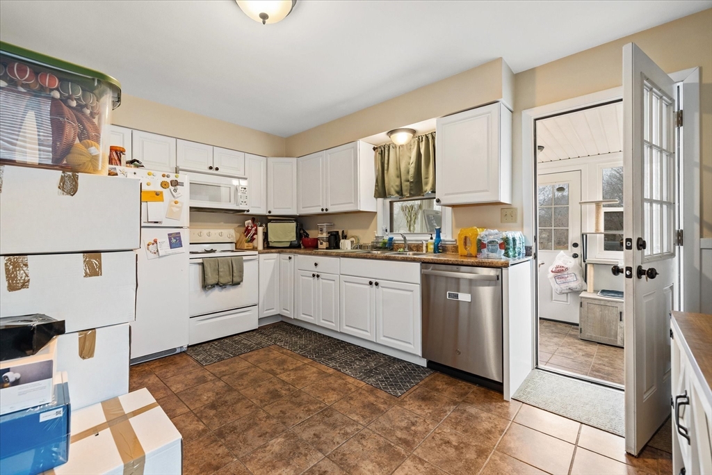 7 Holbrook Road, Unit 2 Oxford, MA 01540 - Photo 8 of 14 a kitchen with white cabinets and white appliances