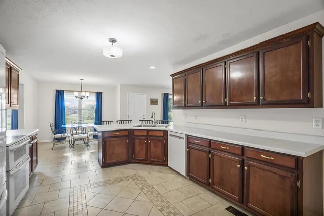 a large kitchen with wooden cabinets and stainless steel appliances