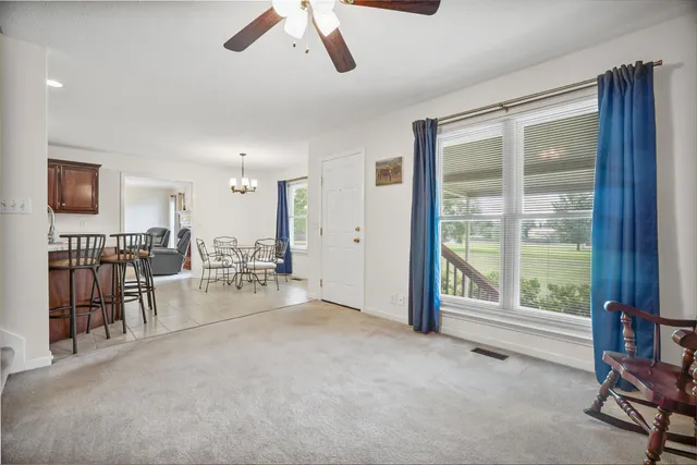 a view of a livingroom with furniture and a window