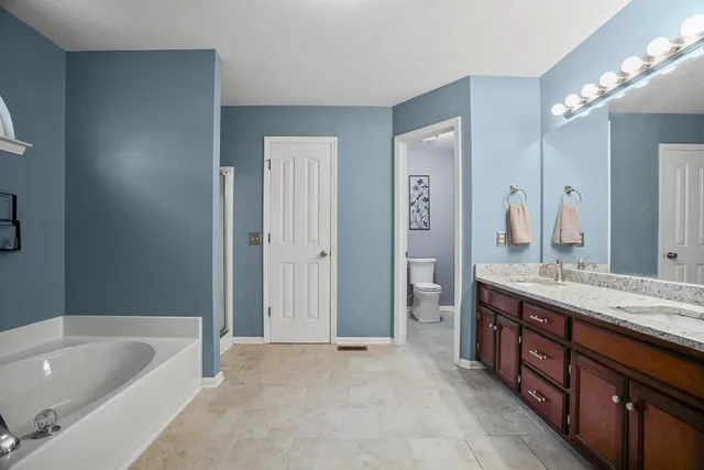 a bathroom with a bathtub and a shower