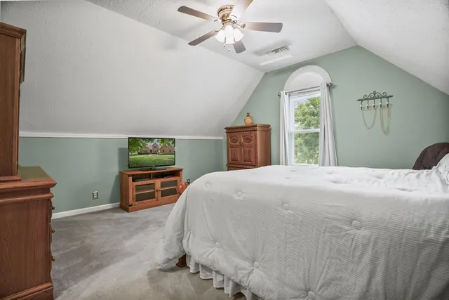 a bedroom with a bed and a dresser