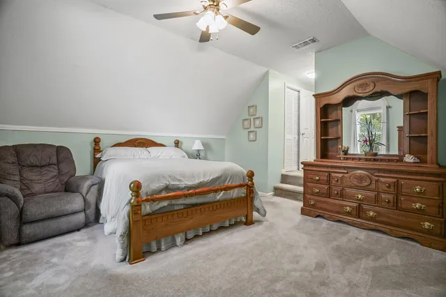 a bed sitting in a bedroom next to a window