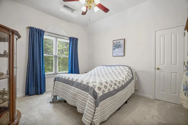 a bed sitting in a bedroom and painting on the wall