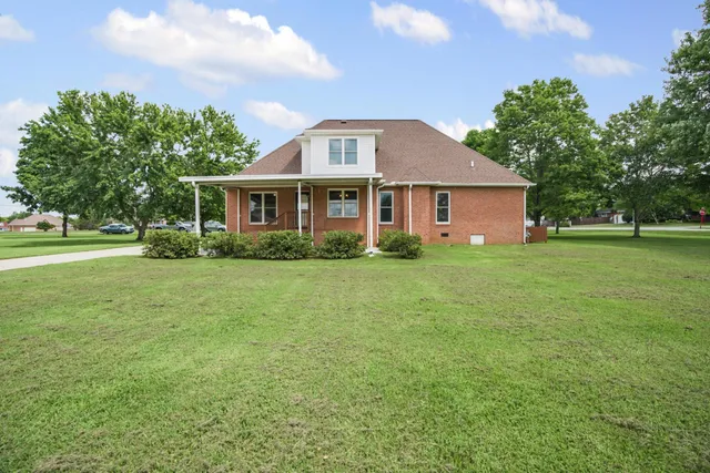 an aerial view of a house with a yard
