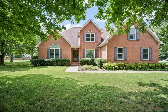an aerial view of a house with a garden and trees