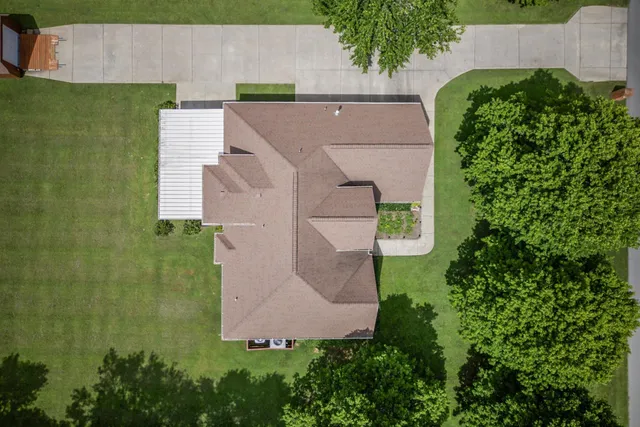 an aerial view of a house with backyard and pool