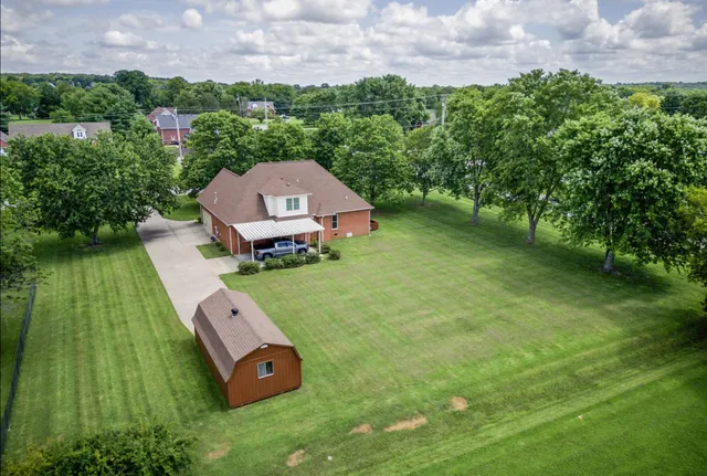 an aerial view of residential houses with outdoor space and street view