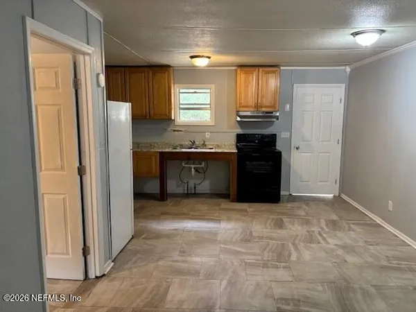 a large kitchen with a refrigerator and a stove top oven