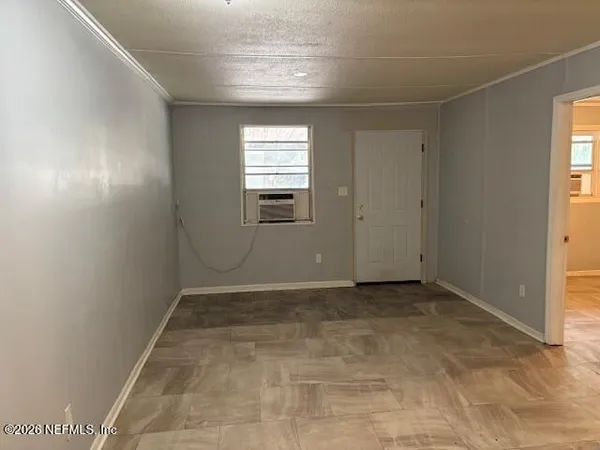 a view of an empty room with a window