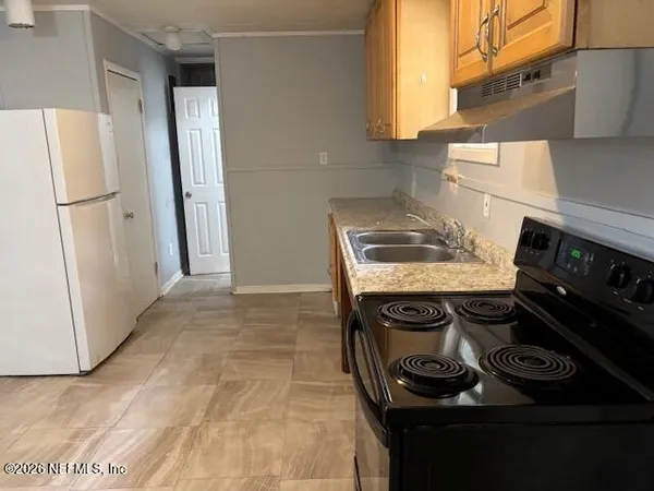 a kitchen with a stove and a refrigerator