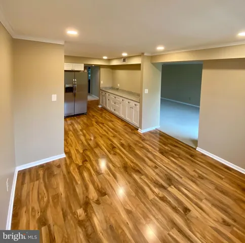 a view of a room with wooden floor